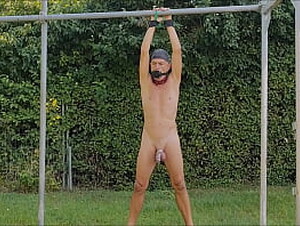 naked slave pig exposed in penis cage outdoor party, tied up, clamps on testicles, pee, BDSM CBT